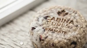 Close-up of a hydrating shampoo bar for curly hair showing texture.