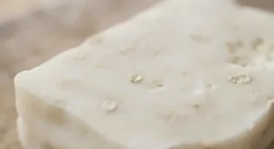 Close-up texture of a nourishing goat milk soap for eczema showing smooth, handcrafted details